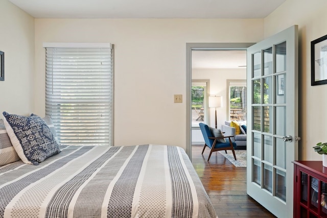 bedroom featuring french doors and dark hardwood / wood-style flooring