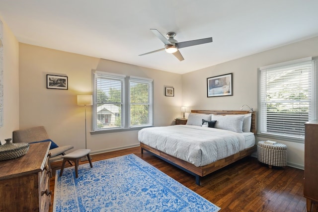 bedroom with ceiling fan and dark hardwood / wood-style floors