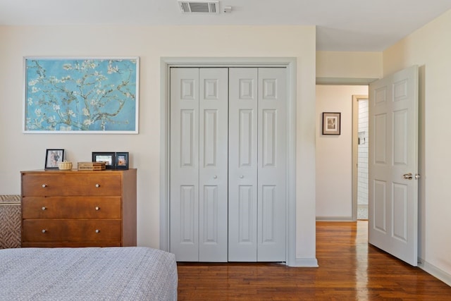 bedroom featuring a closet and dark hardwood / wood-style flooring