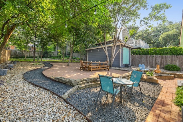 view of yard featuring a patio and a shed