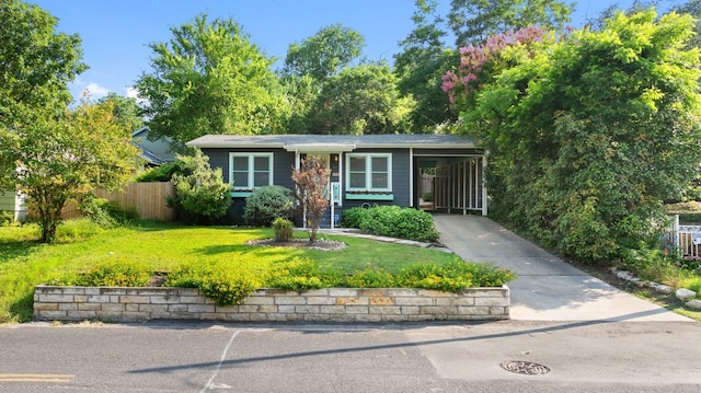 single story home featuring a front lawn and a carport