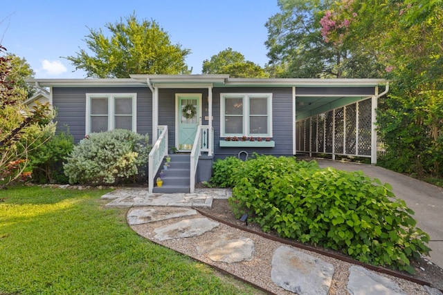 view of front facade with a front yard and a carport