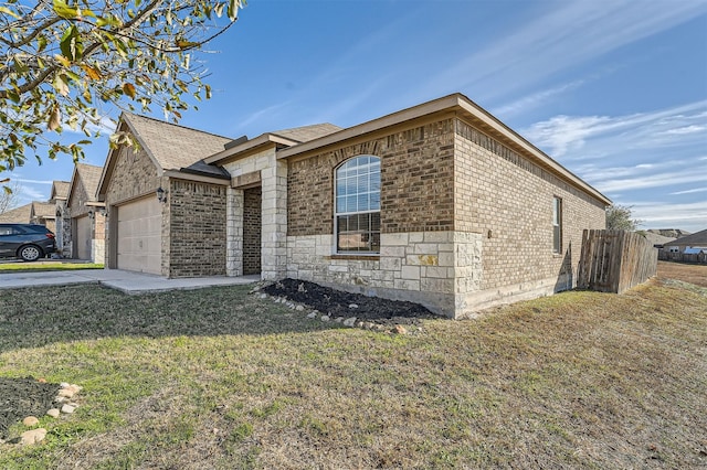 view of front of property with a front yard and a garage