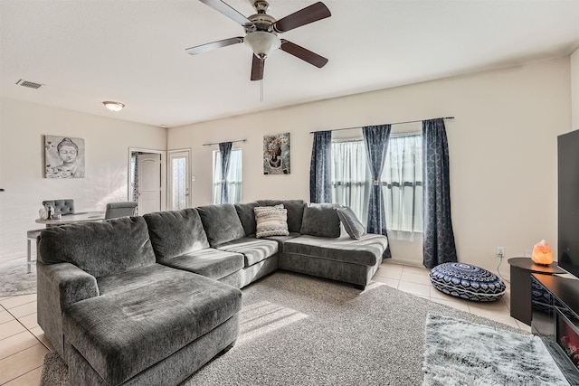 tiled living room featuring ceiling fan