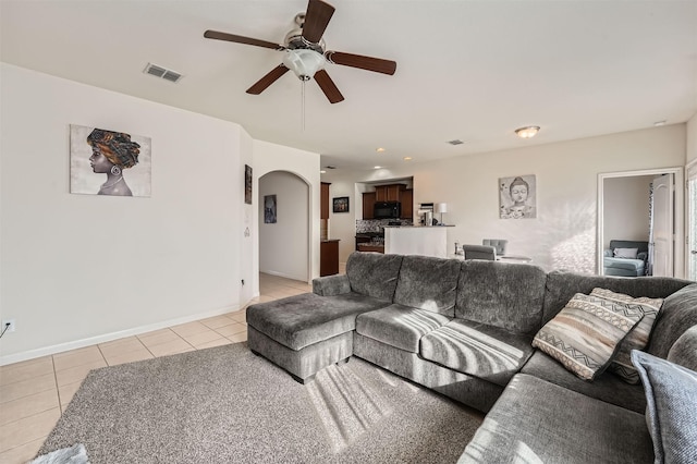 tiled living room with ceiling fan