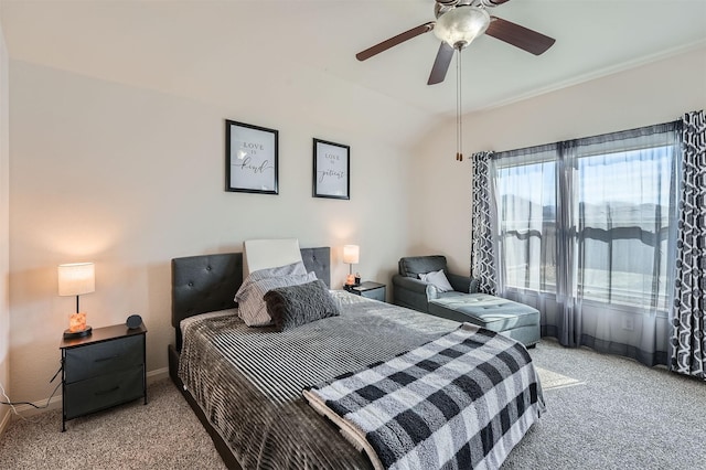 bedroom with ceiling fan, vaulted ceiling, and light colored carpet