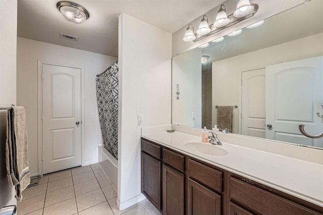 bathroom featuring vanity, shower / bath combination with curtain, and tile patterned floors