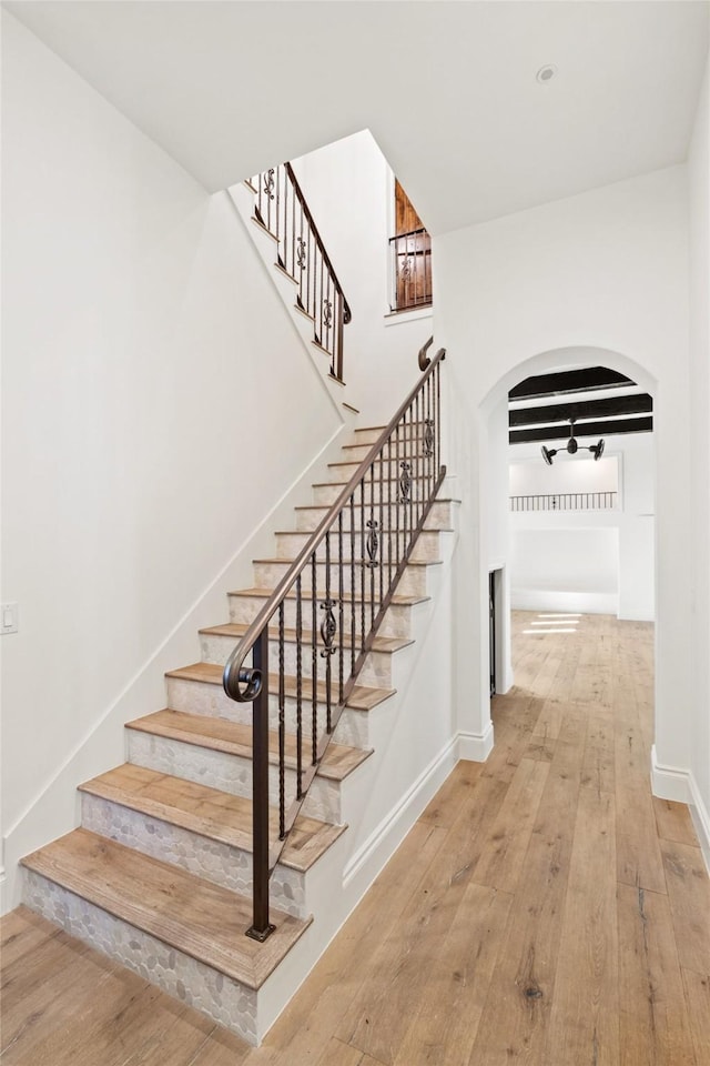 stairway with hardwood / wood-style flooring