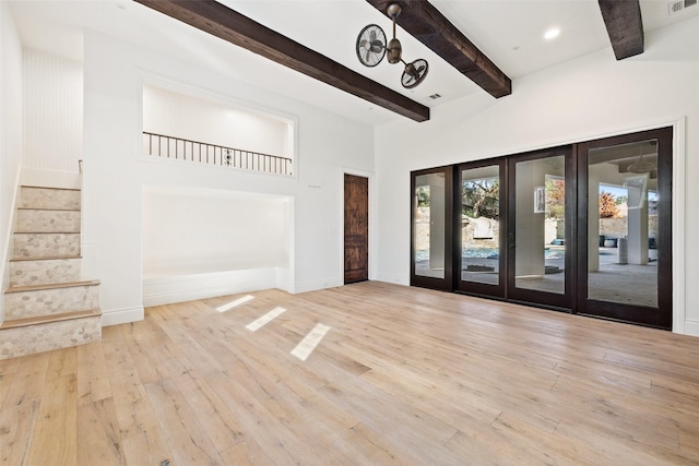 interior space with french doors, light hardwood / wood-style floors, and beamed ceiling