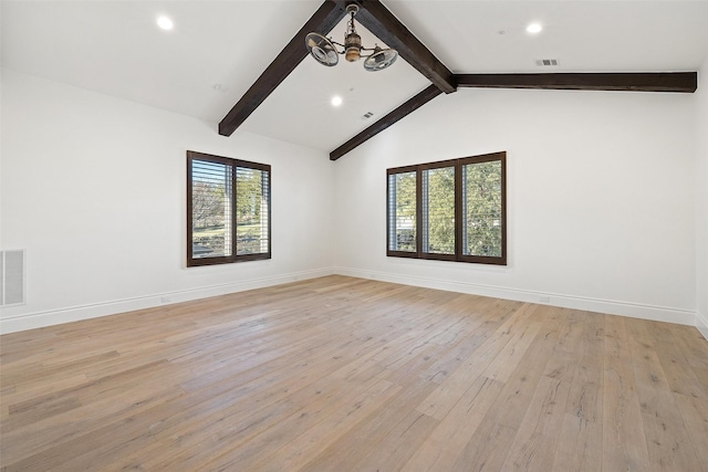 empty room with light hardwood / wood-style floors, vaulted ceiling with beams, and a chandelier