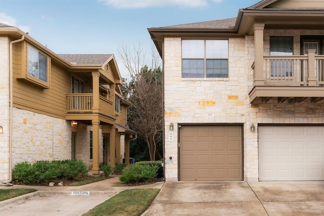 view of front facade with a balcony and a garage