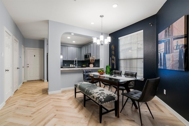 dining space with a chandelier and light parquet floors