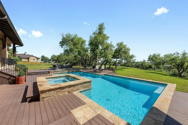 view of pool featuring a pool with connected hot tub, a yard, and a deck
