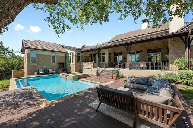 view of pool with a wooden deck, an in ground hot tub, and outdoor lounge area