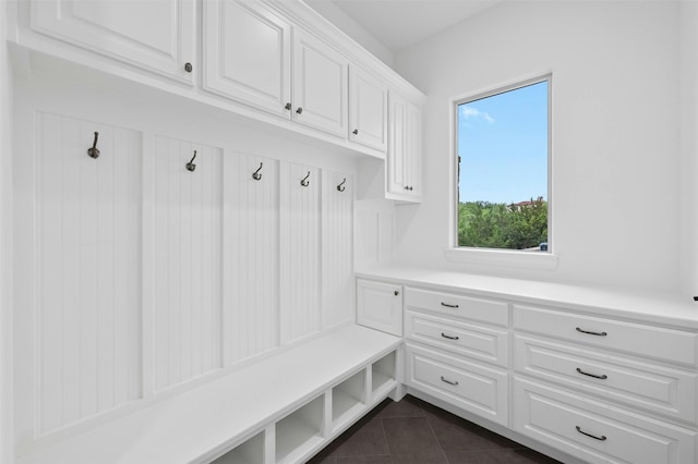 mudroom featuring dark tile patterned floors