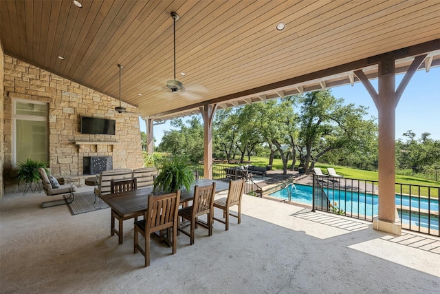 view of patio / terrace with ceiling fan and an outdoor stone fireplace