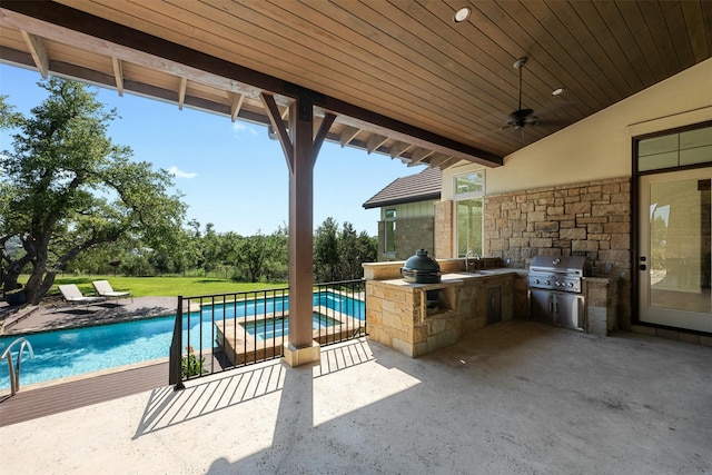 view of patio with sink, an outdoor kitchen, ceiling fan, and area for grilling