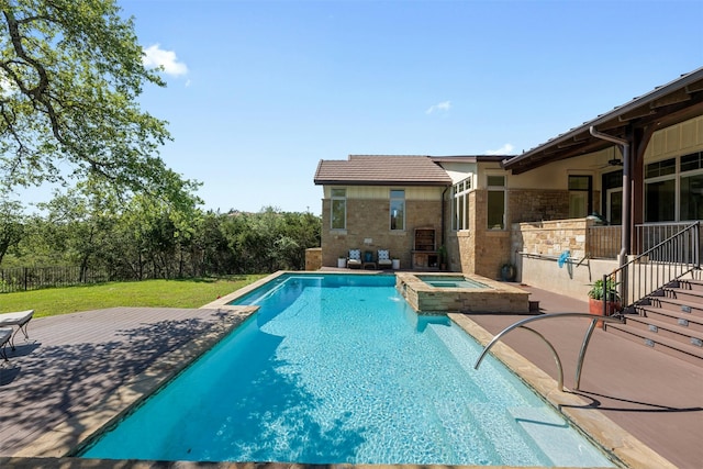 view of pool featuring ceiling fan, a lawn, an in ground hot tub, and a patio area