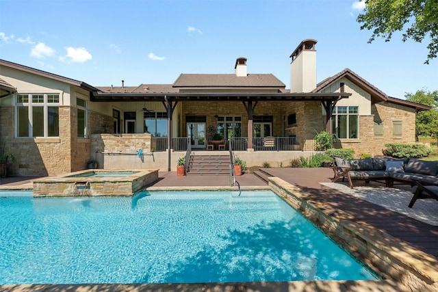 view of pool with an outdoor hangout area, a patio, pool water feature, and an in ground hot tub