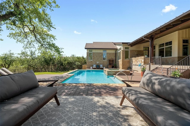 view of pool with a patio area and an in ground hot tub