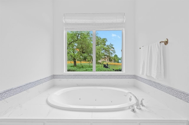 bathroom with a washtub and a wealth of natural light