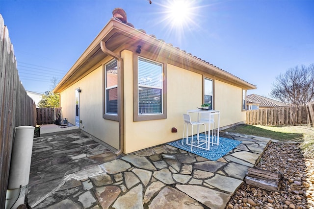 view of side of property featuring a patio