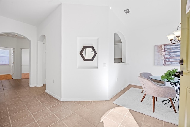 interior space with vaulted ceiling and a chandelier