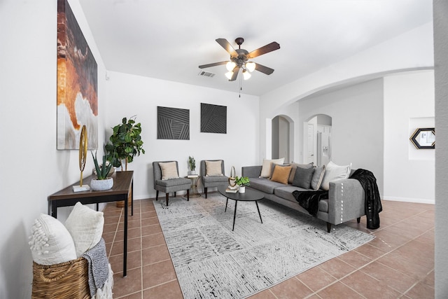 living room with ceiling fan and tile patterned floors