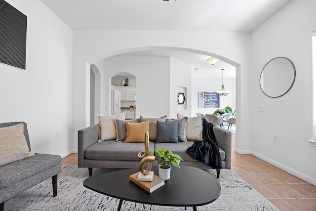 living room with a chandelier and light tile patterned floors