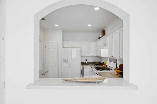 kitchen featuring white appliances and white cabinetry