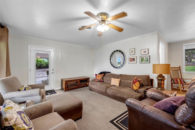 living room featuring ceiling fan, a healthy amount of sunlight, and light carpet