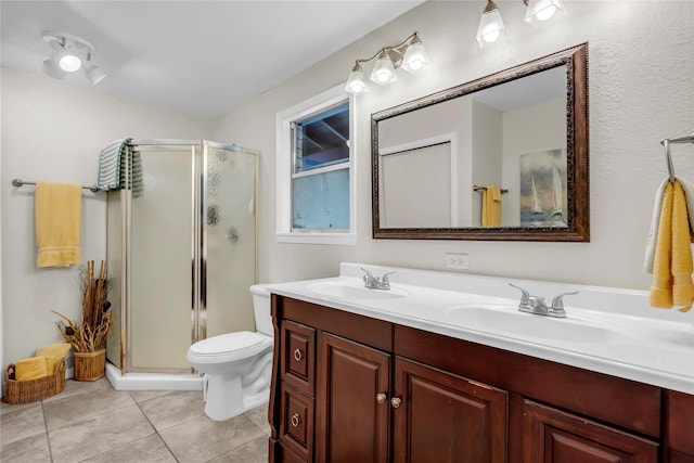 bathroom with toilet, a shower with door, vanity, and tile patterned floors