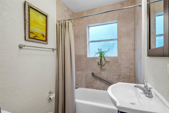 bathroom featuring sink and shower / bath combo with shower curtain