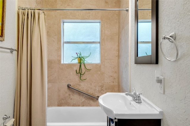 bathroom with shower / bath combo with shower curtain and vanity