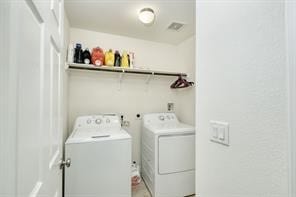 laundry area with washing machine and dryer