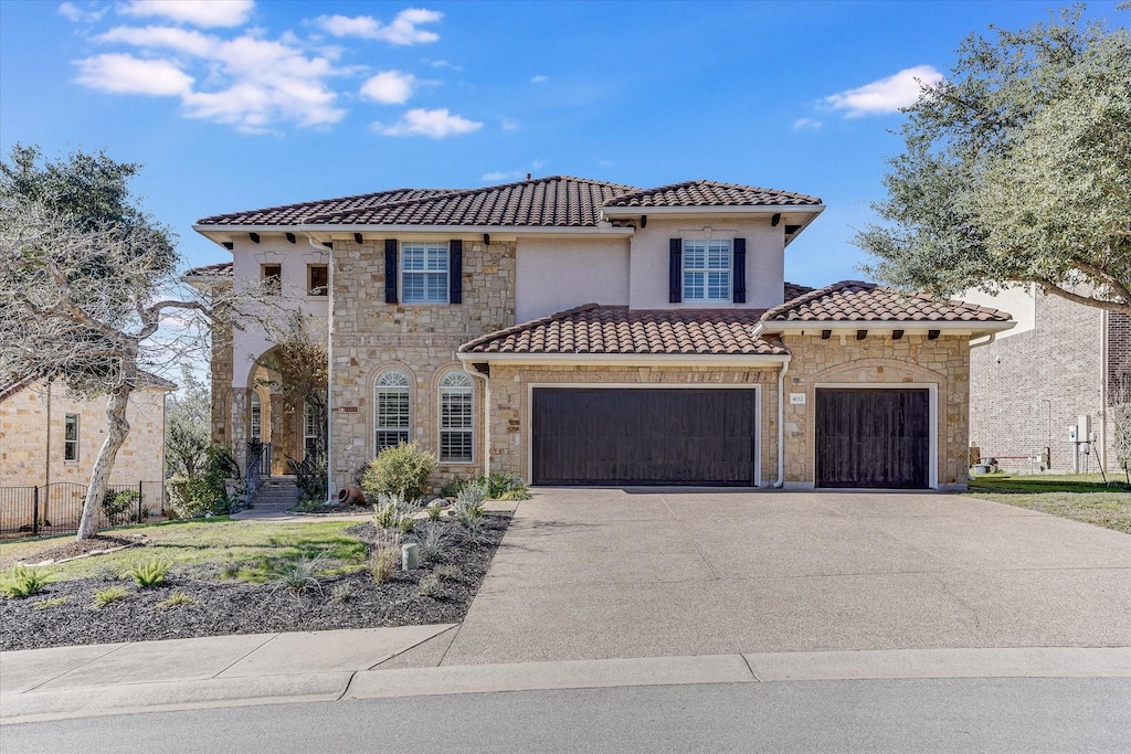 mediterranean / spanish home featuring a garage