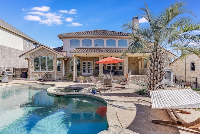 view of swimming pool featuring an in ground hot tub, a patio area, and area for grilling