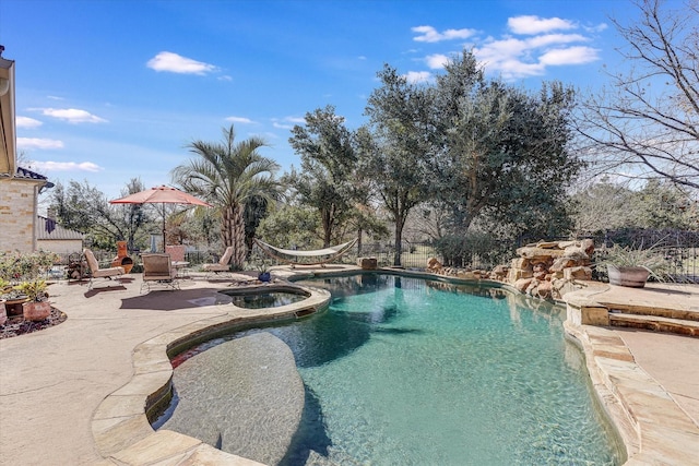 view of swimming pool with an in ground hot tub and a patio