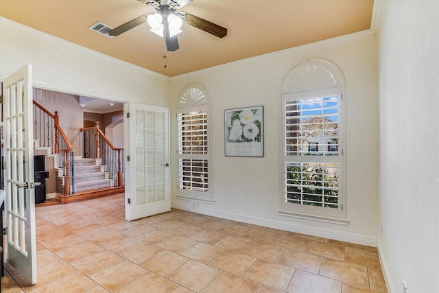 interior space with ceiling fan, french doors, crown molding, and light tile patterned flooring