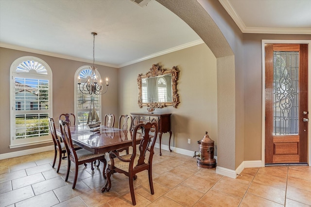 tiled dining space with a chandelier, crown molding, and plenty of natural light