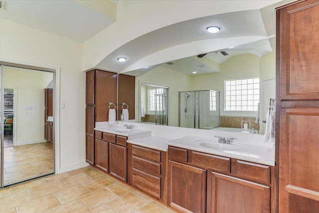 bathroom with tile patterned floors, an enclosed shower, vanity, and vaulted ceiling