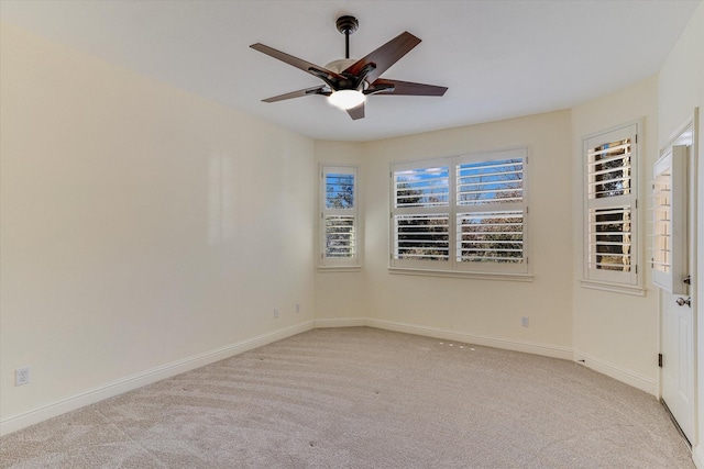 unfurnished room featuring light colored carpet and ceiling fan