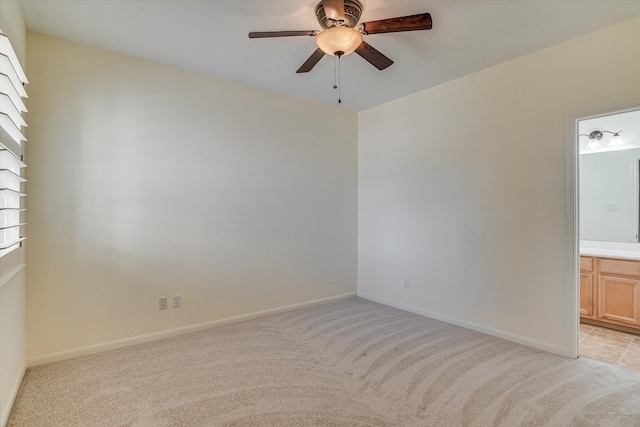 unfurnished room with ceiling fan and light carpet