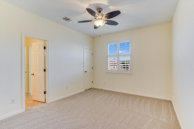 spare room with light carpet and ceiling fan