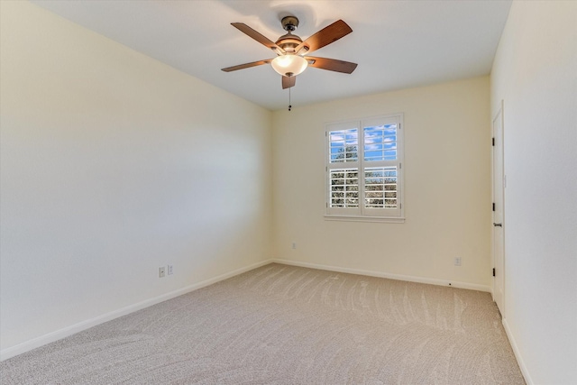 unfurnished room with ceiling fan and light carpet