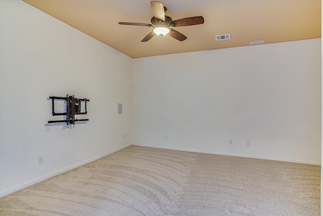 spare room featuring ceiling fan and carpet flooring