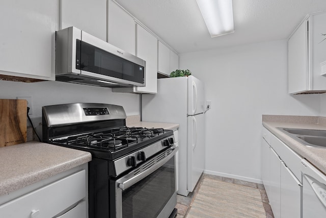 kitchen featuring white cabinets, stainless steel appliances, and sink