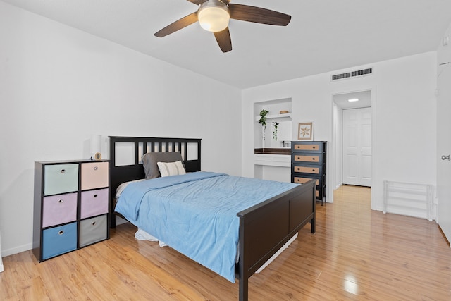 bedroom with ceiling fan and light hardwood / wood-style floors