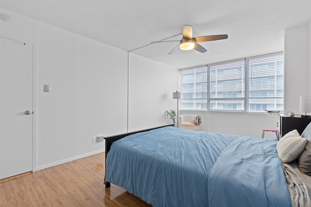 bedroom with ceiling fan and light hardwood / wood-style flooring