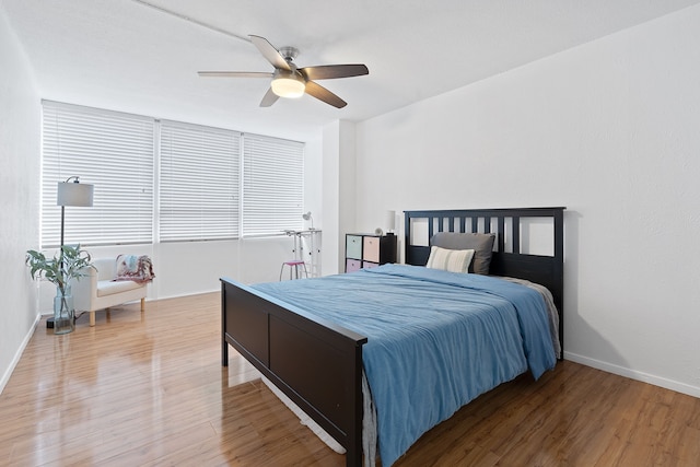 bedroom with ceiling fan and wood-type flooring